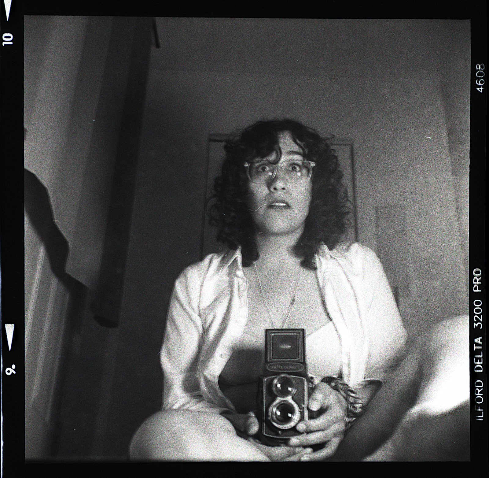 Self-portrait with medium-format camera, looking up